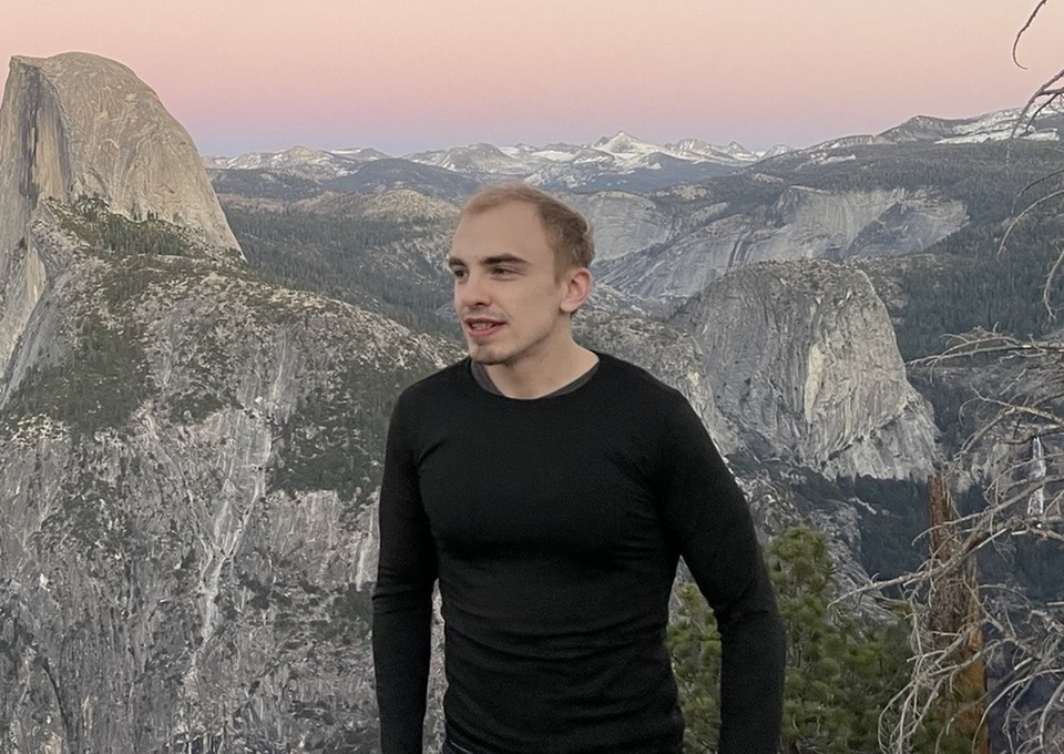 Ben Krause overlooking Half Dome and the Yosemite mountains at sunset